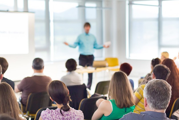 Man giving speech in front of audience 